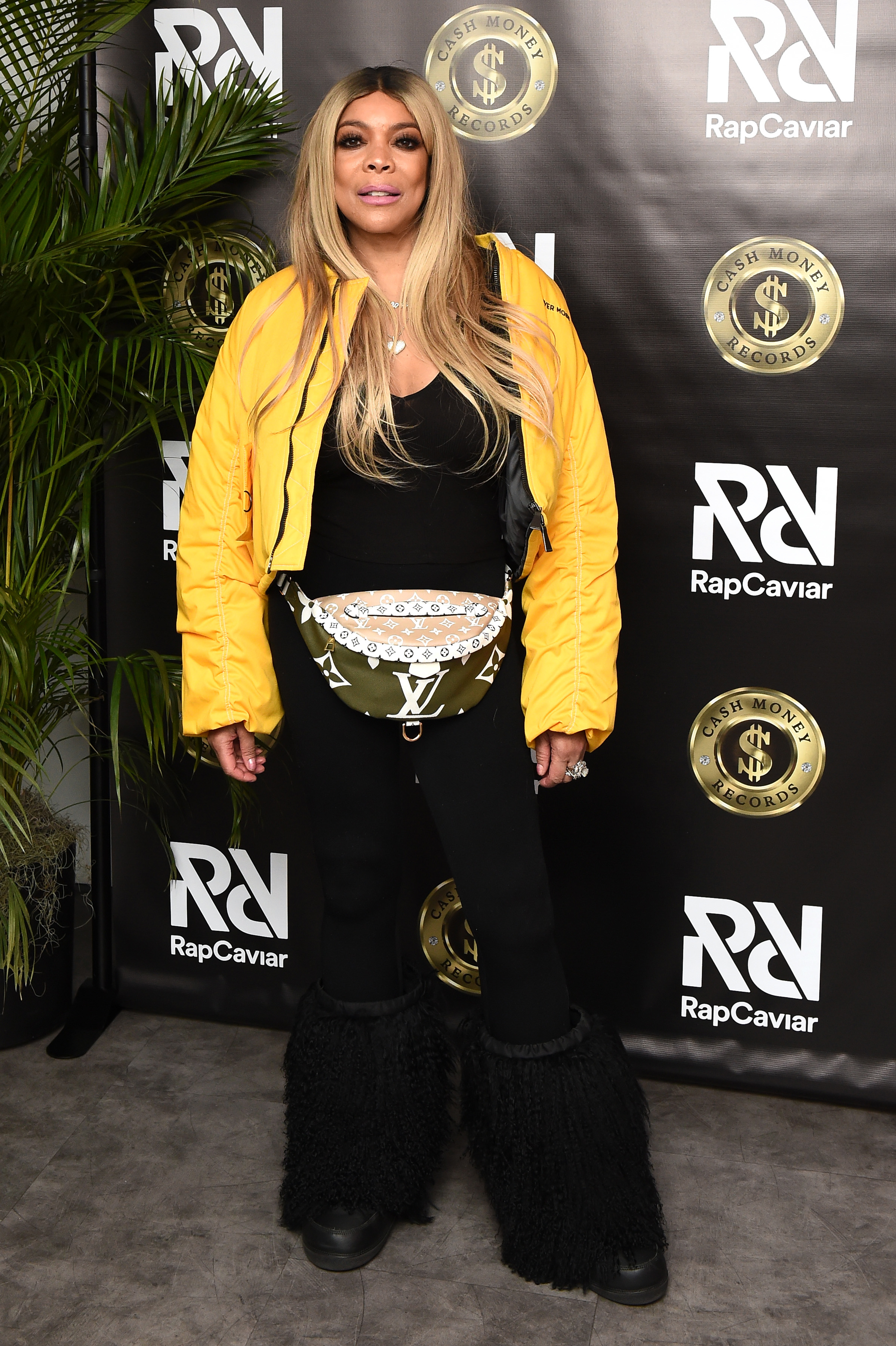Wendy Williams in outfit with a jacket and fanny pack, at RapCaviar event