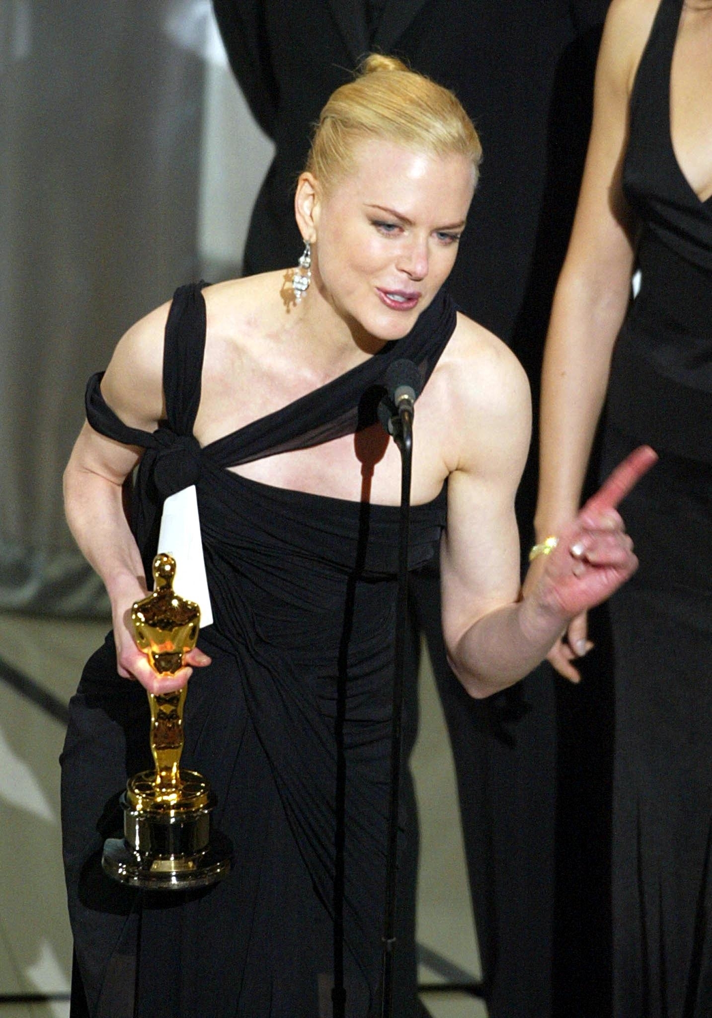 nicole holding her award while giving her speech on stage