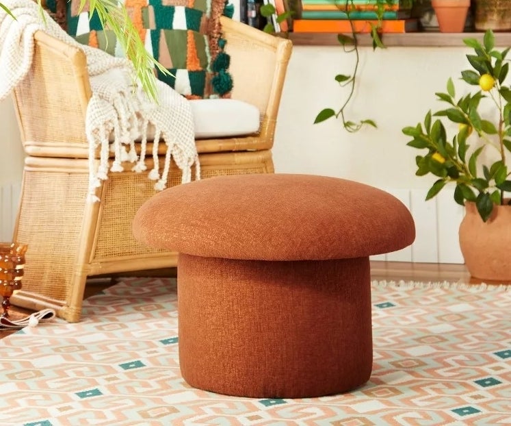 The rust red mushroom stool in a living room