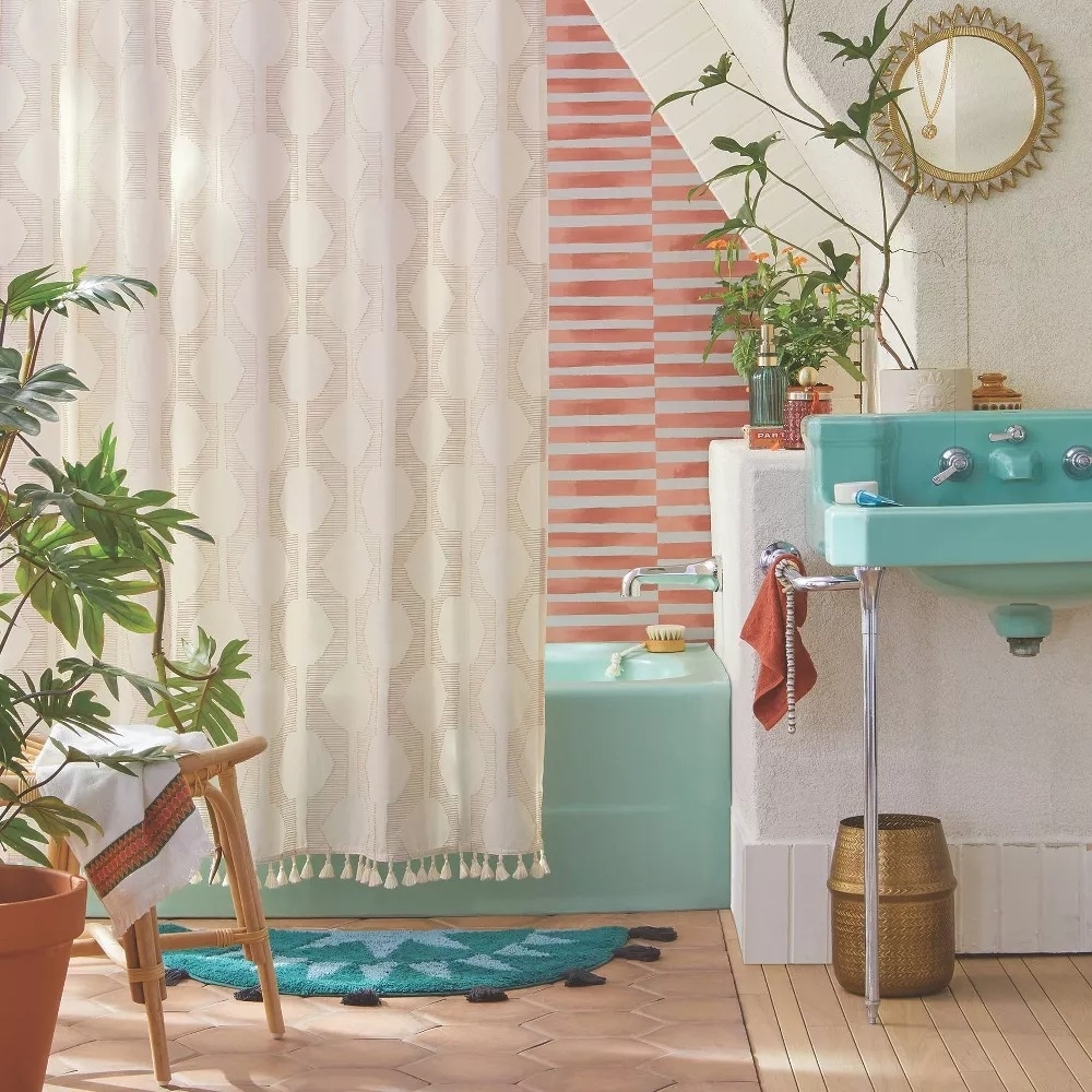 A trendy bathroom with a textured shower curtain