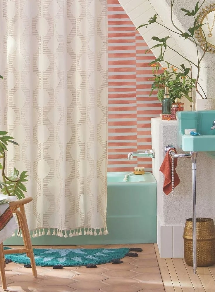 A trendy bathroom with a textured shower curtain