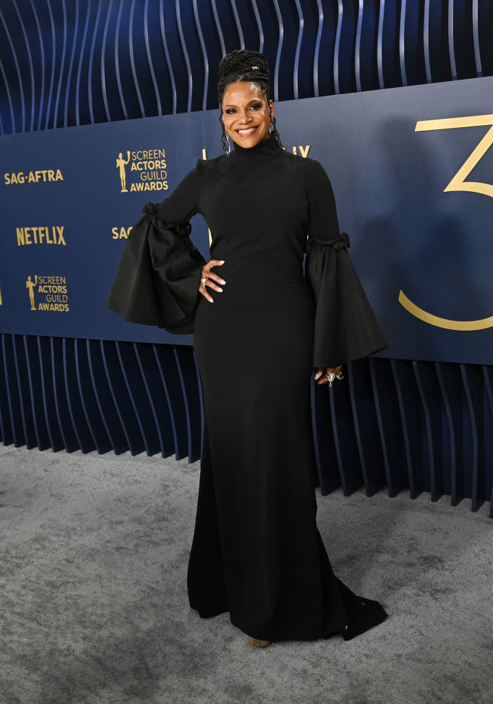 Audra McDonald  in a long gown with peplum sleeves