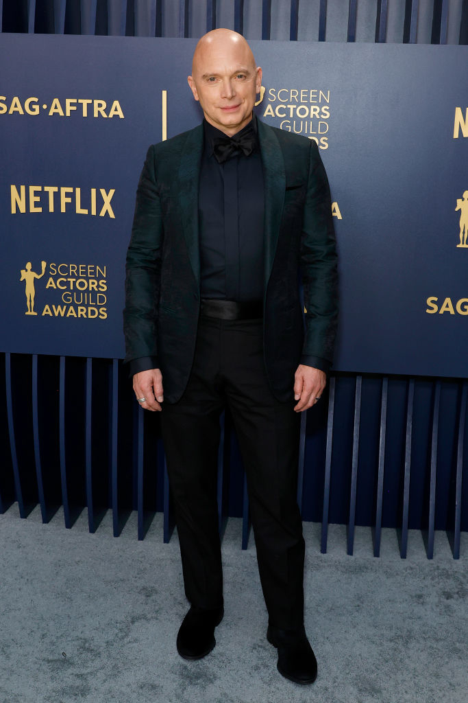 Michael Cerveris in a dark suit with an embellished blazer