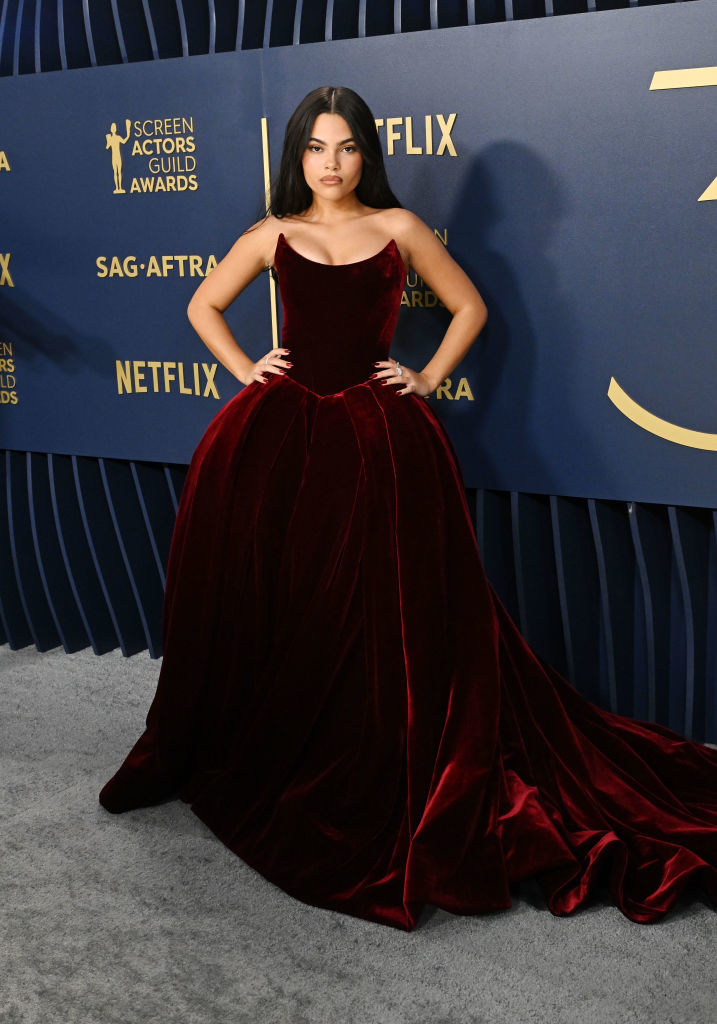 Ariana Greenblatt in a velvet gown with a trailing skirt posing at an event