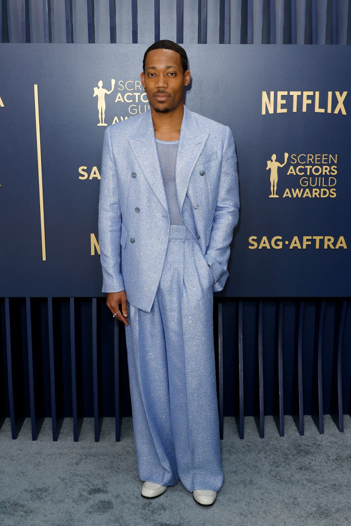 Tyler James Williams  in a glittering suit with wide legged pants