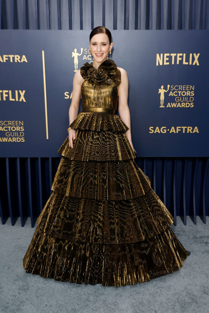 Rachel Brosnahan in a tiered metallic gown with a large bow at the neck