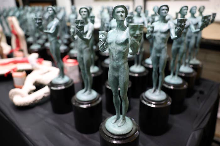 Rows of Screen Actors Guild Award statuettes on a table