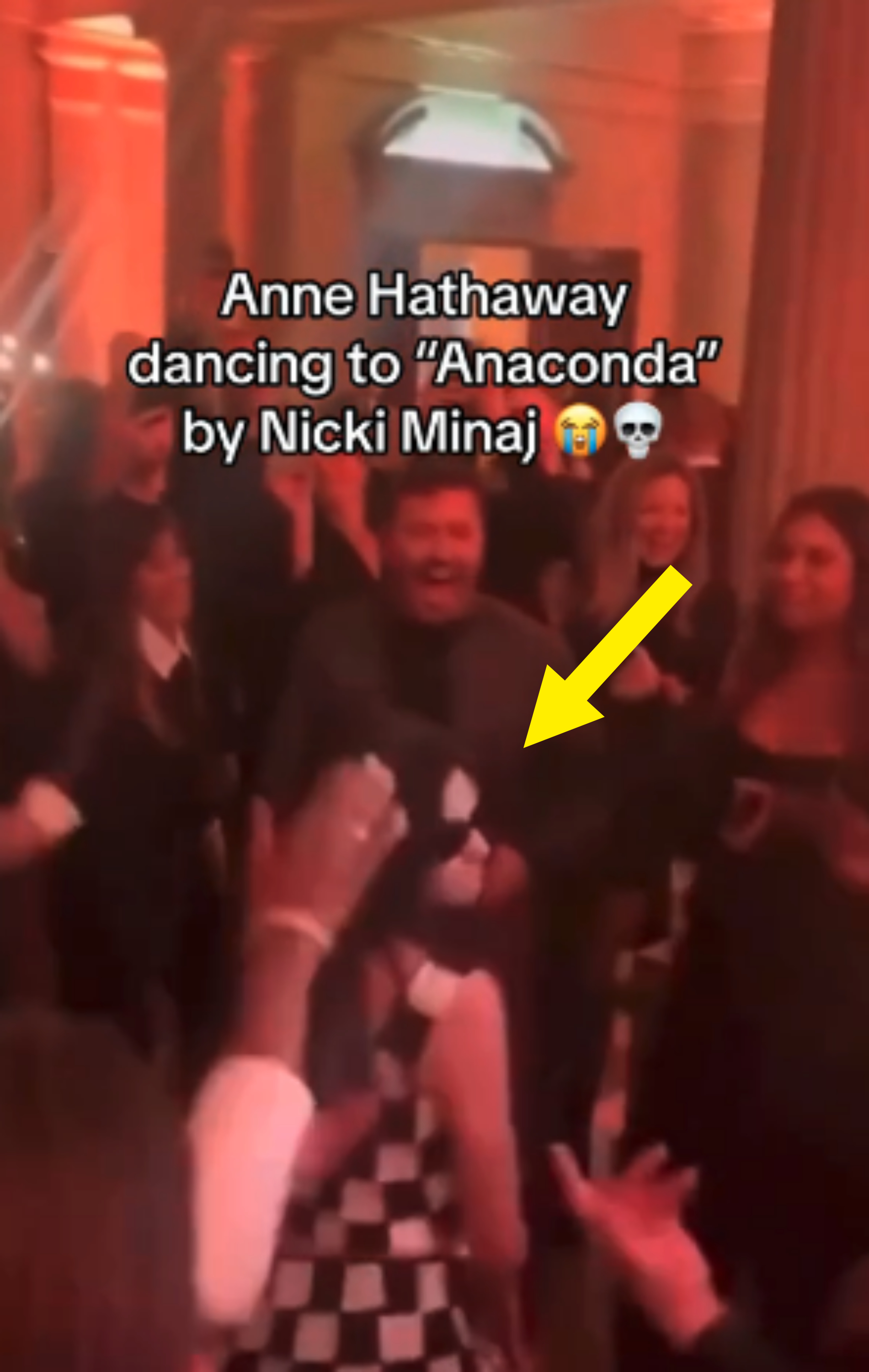 Anne Hathaway dancing to &quot;Anaconda&quot; by Nicki Minaj in a lively event surrounded by people