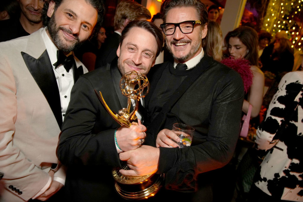 Kieran Culkin holding his Emmy award while posing with Pedro Pascal