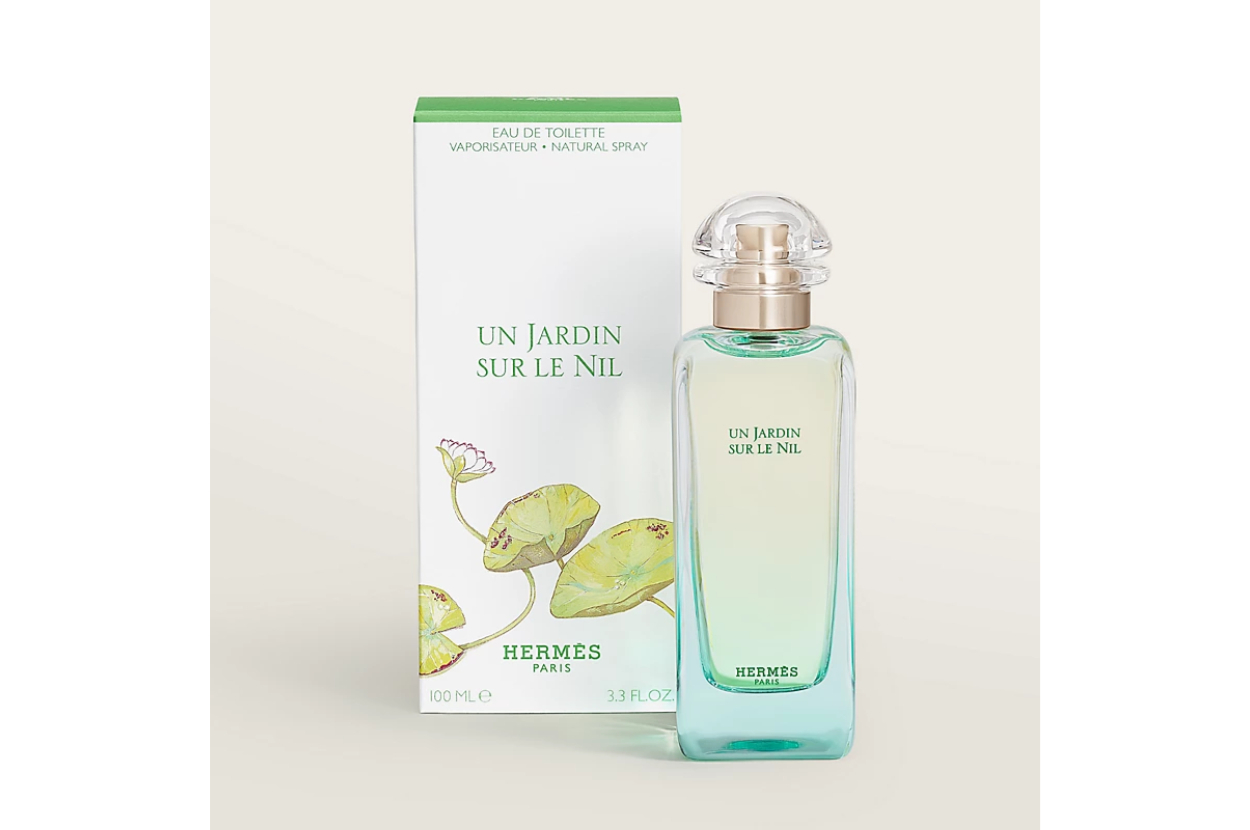 Hermès &#x27;Un Jardin Sur Le Nil&#x27; perfume bottle next to its packaging with a floral design