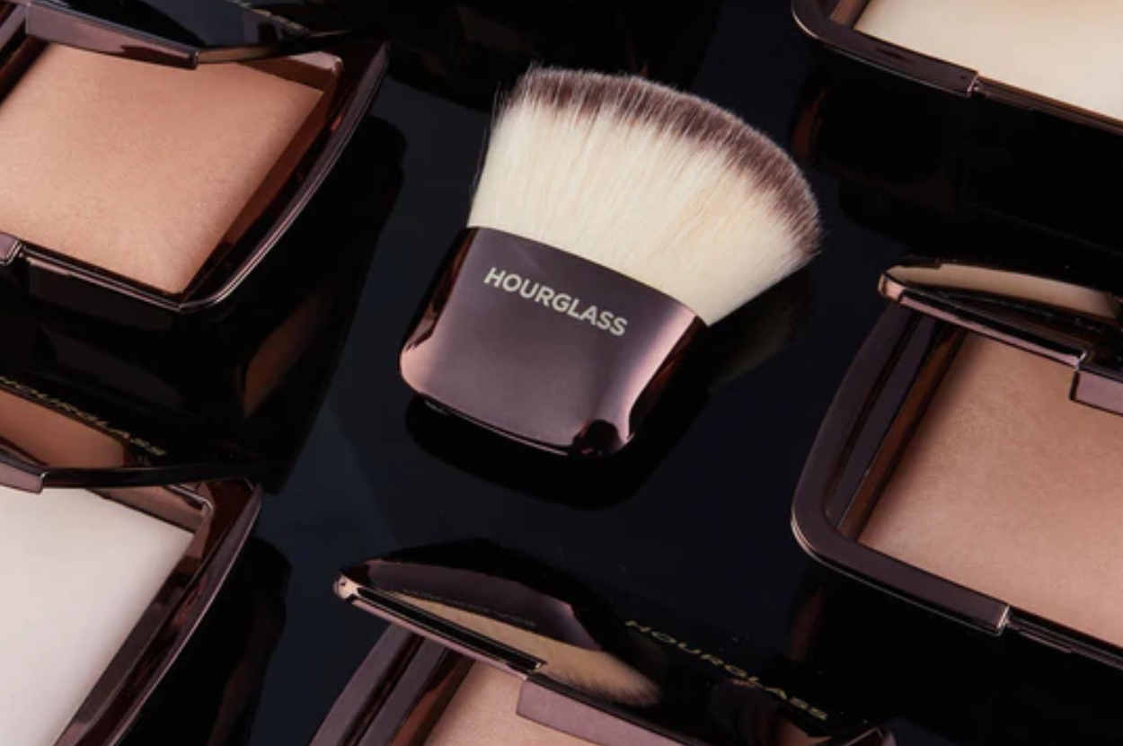 Makeup brush and several compacts with &quot;HOURGLASS&quot; brand visible