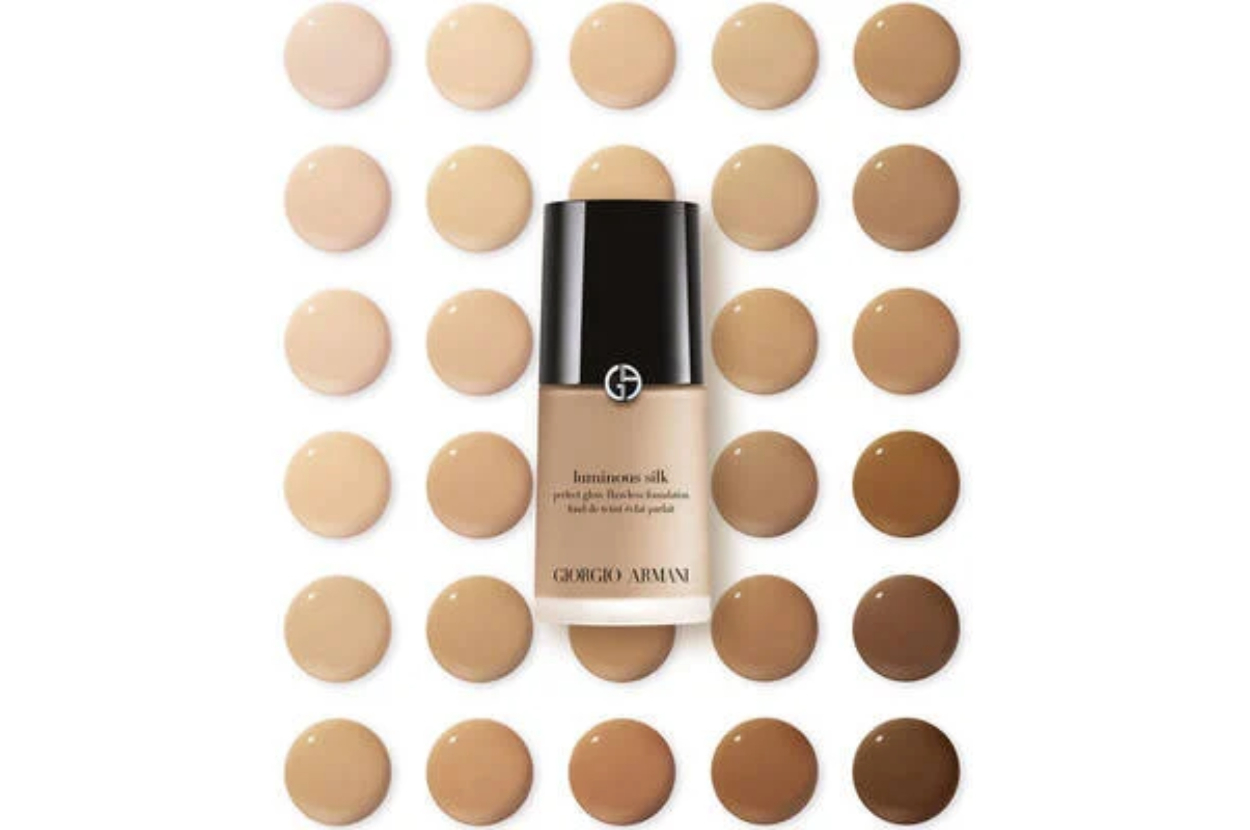Armani foundation bottle surrounded by various shades of makeup