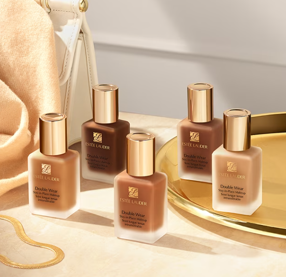 Five bottles of Estée Lauder Double Wear foundation in various shades on a golden tray