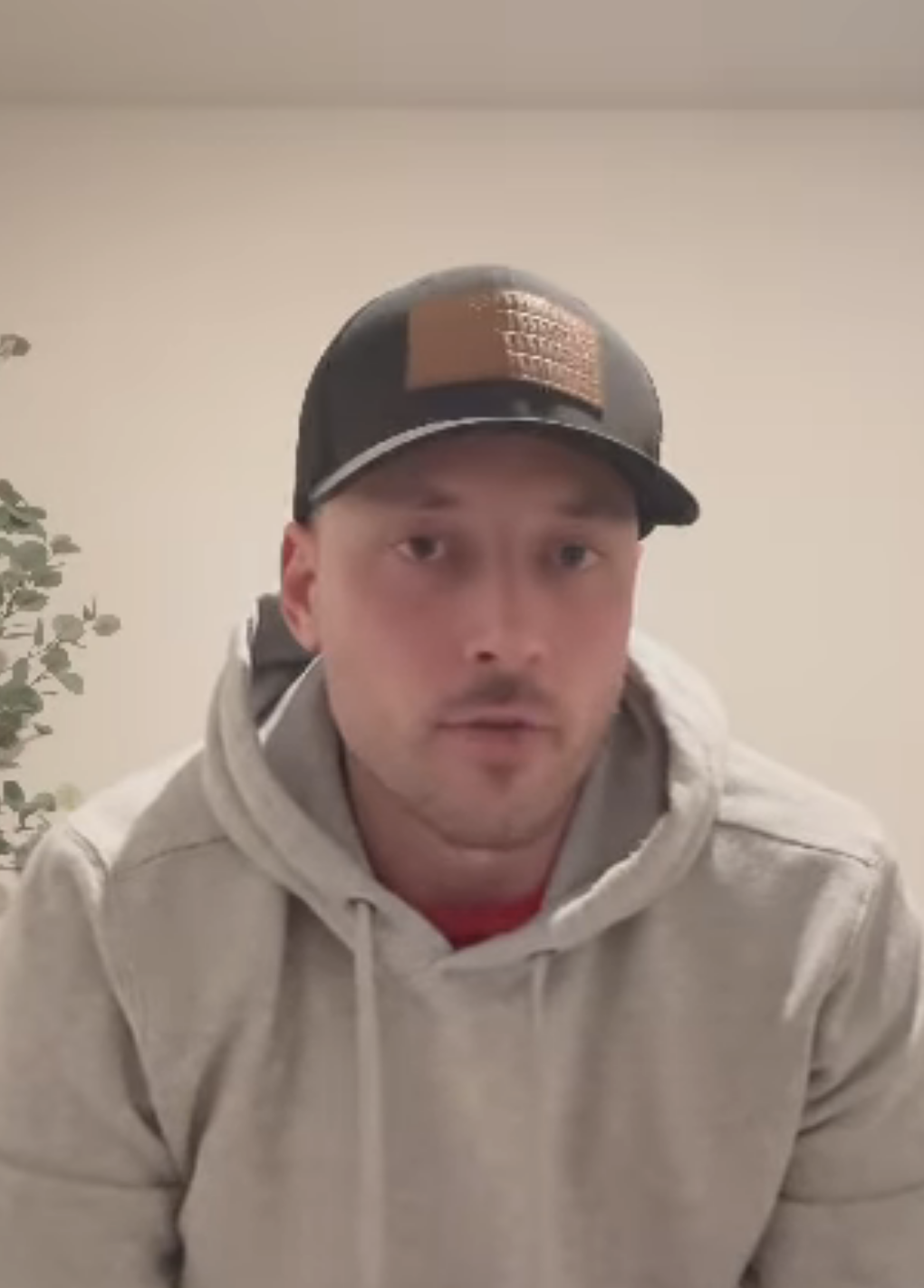 Jeramey in a cap and hoodie speaking on a video