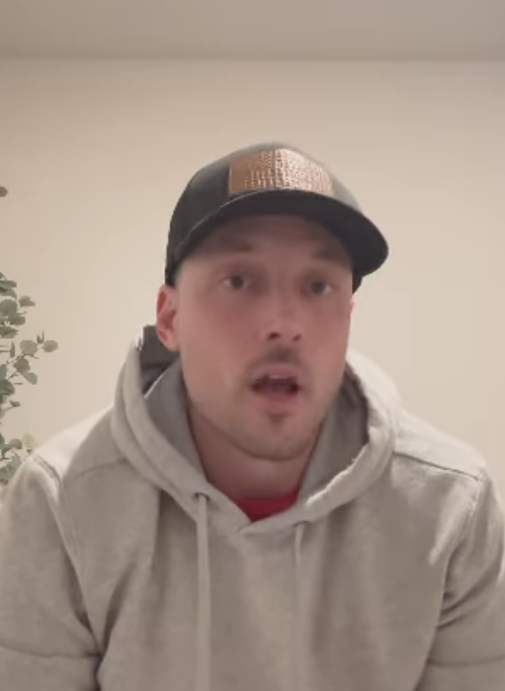 Man in white cap and hoodie speaks, with text overlay about product engagement