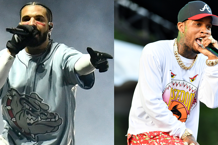 Drake in a graphic tee and Tory Lanez in a printed white tee perform on stage