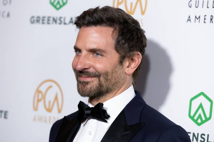 A closeup of Bradley Cooper at an event wearing a tuxedo