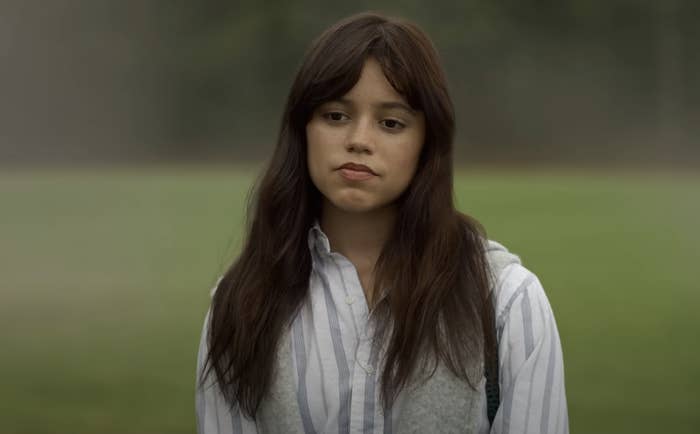 Jenna as a woman outdoors with striped, collared shirt, looking thoughtful in a scene from the film