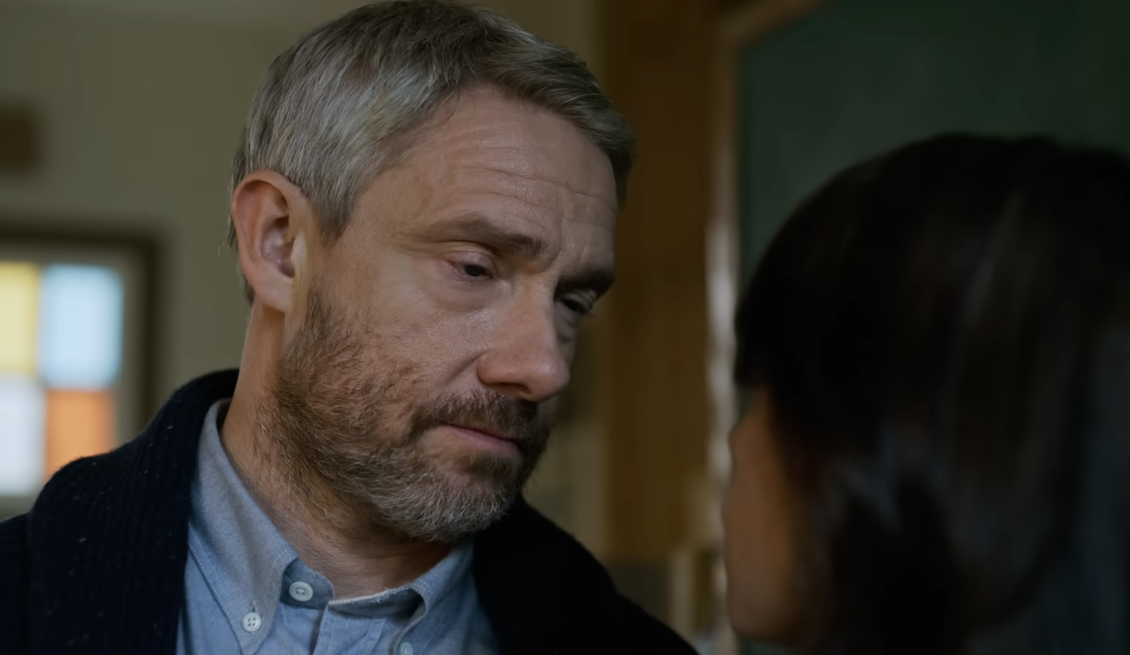 Martin in a sweater looking at Jenna up close in a scene from the film