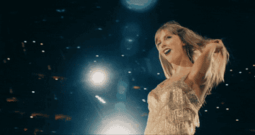 Taylor Swift performing on stage in a sparkling dress