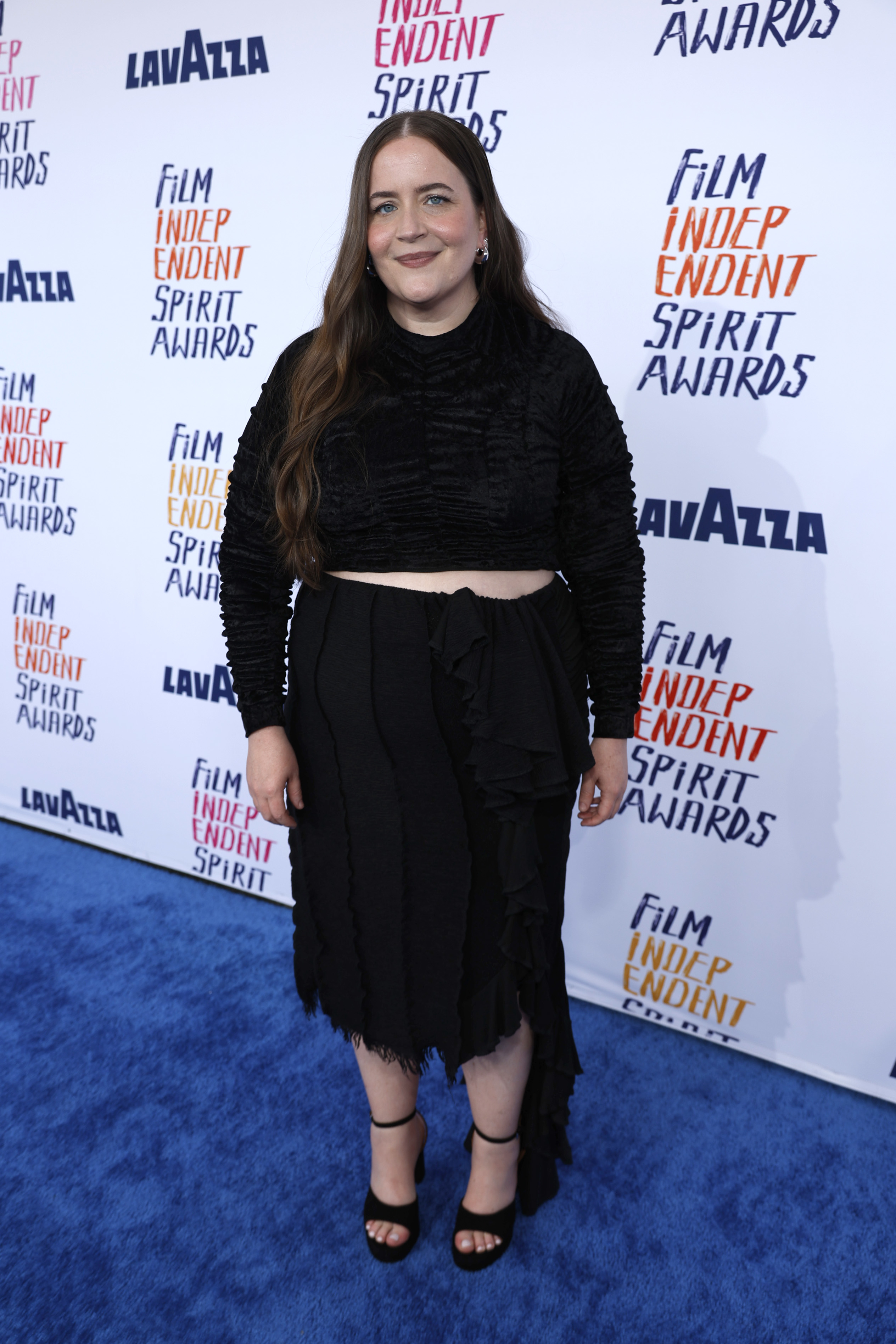 Aidy in a textured crop top and skirt with fringe details, posing at the Independent Spirit Awards