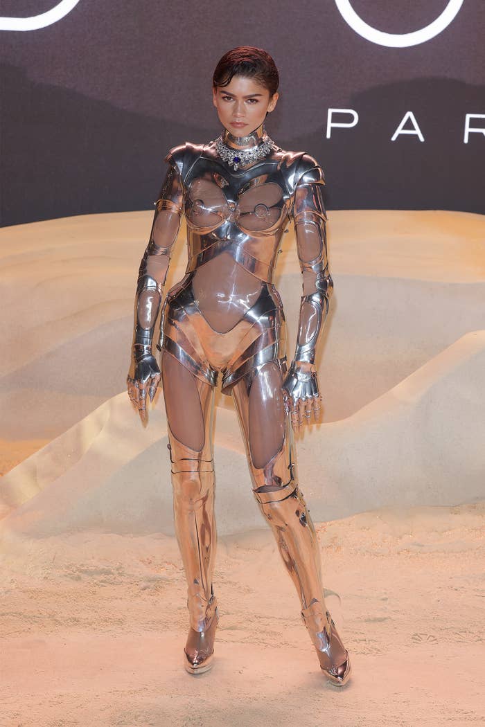 Zendaya wearing a futuristic metallic bodysuit with a high neck and structured shoulders