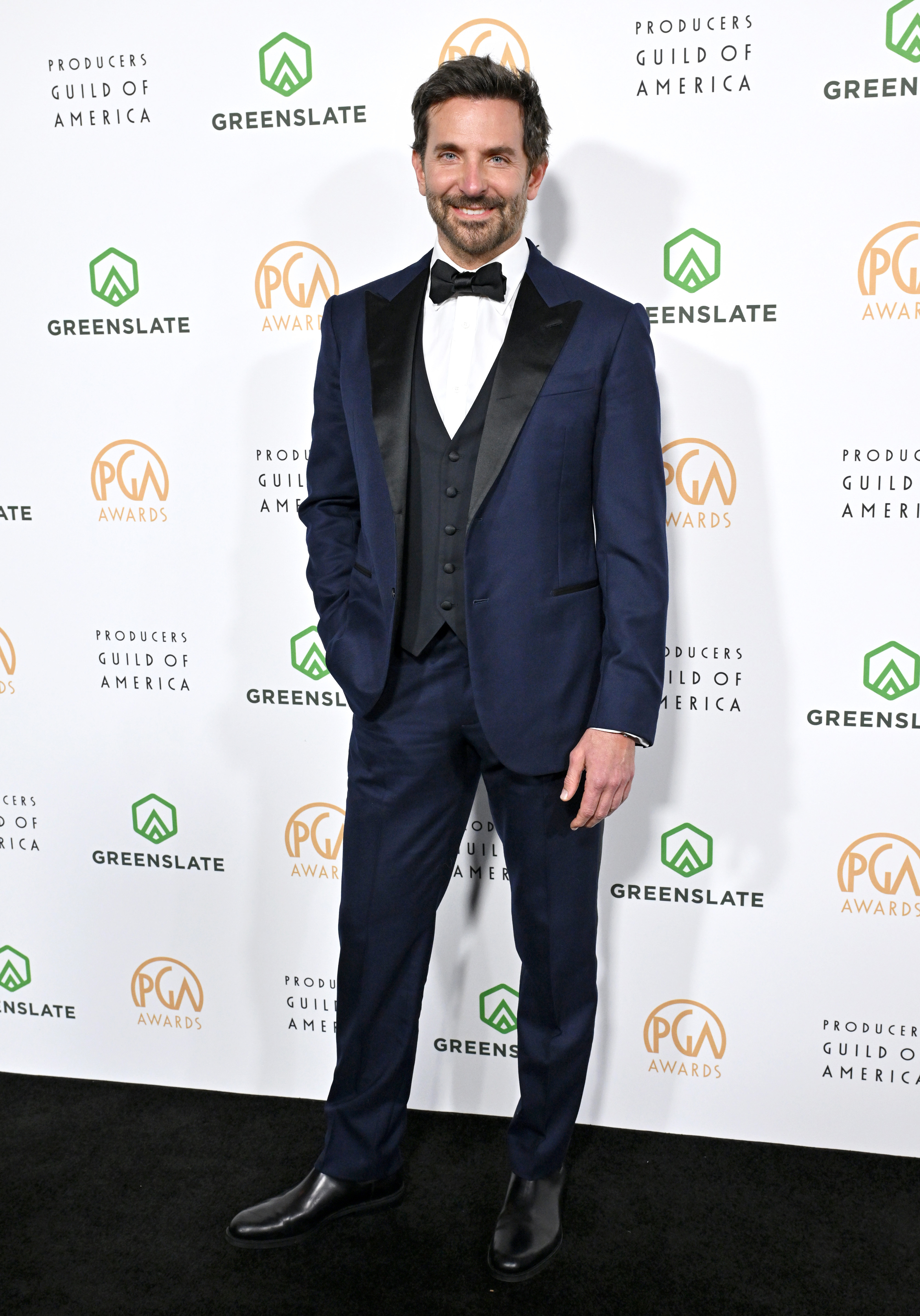 Bradley in a tuxedo with bow tie posing at the Producers Guild Awards