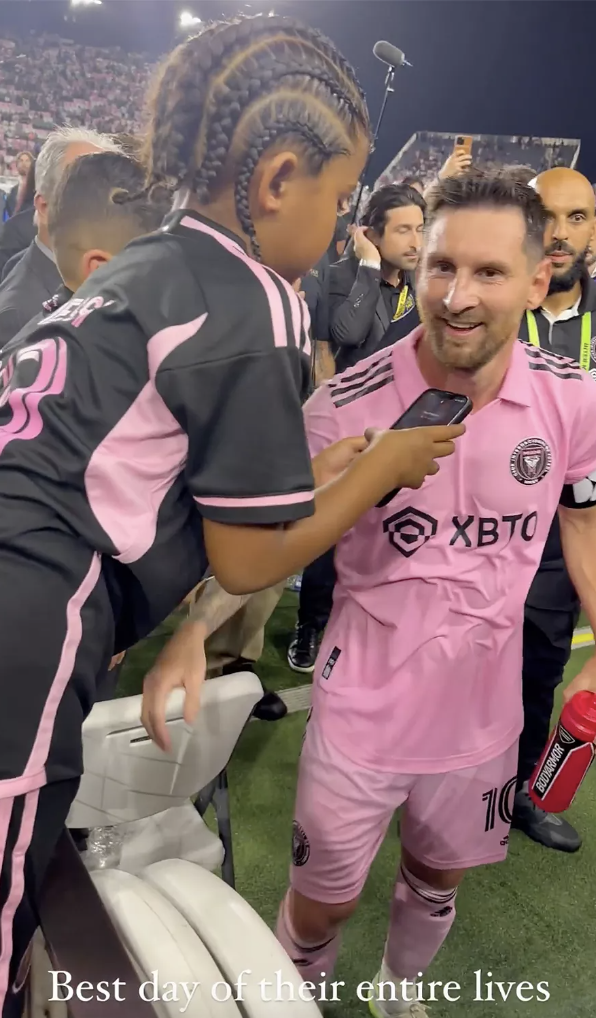 Child in soccer uniform shows phone to Lionel Messi on field; text overlay says &quot;Best day of their entire lives.&quot;