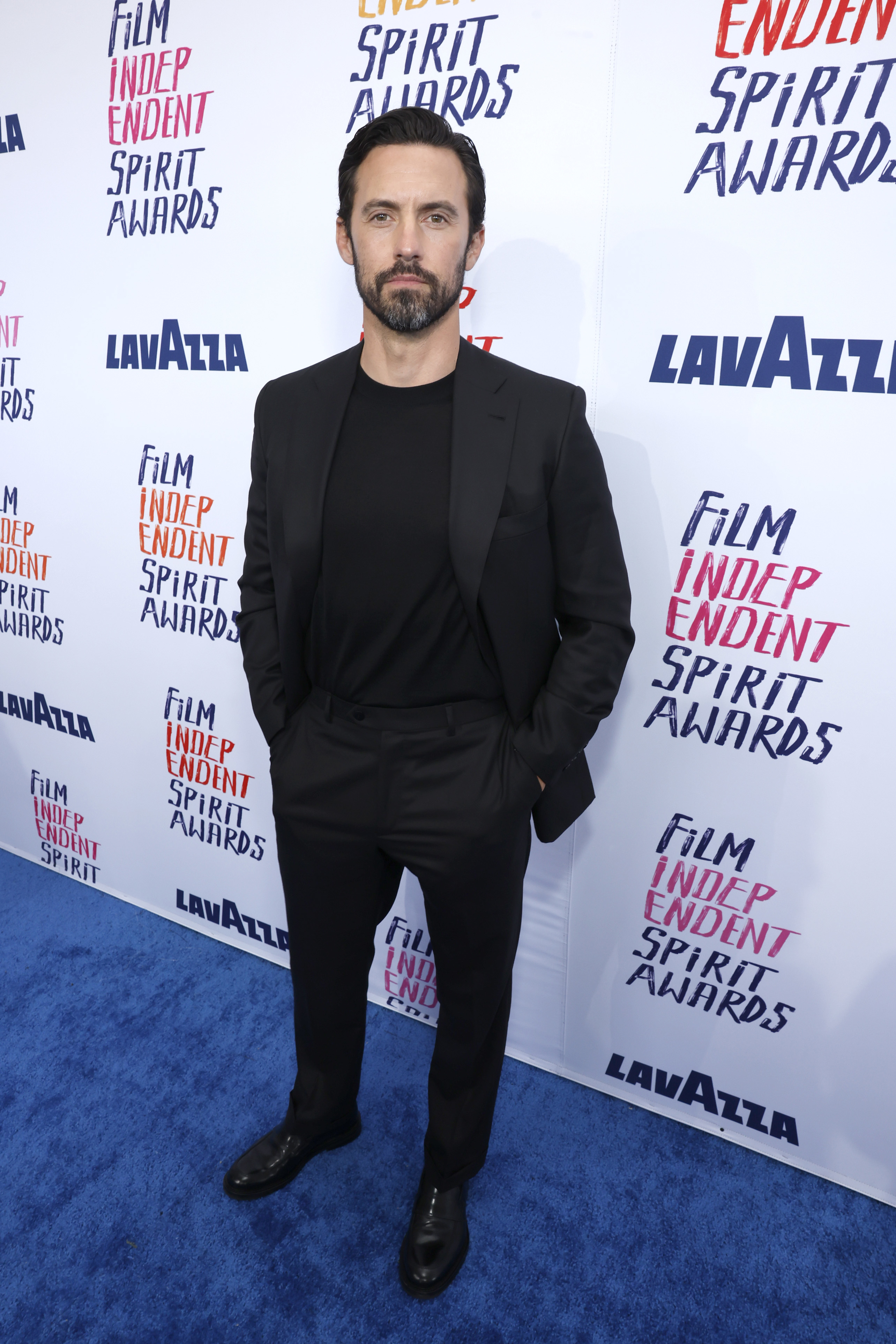 Milo in a suit poses at the Film Independent Spirit Awards