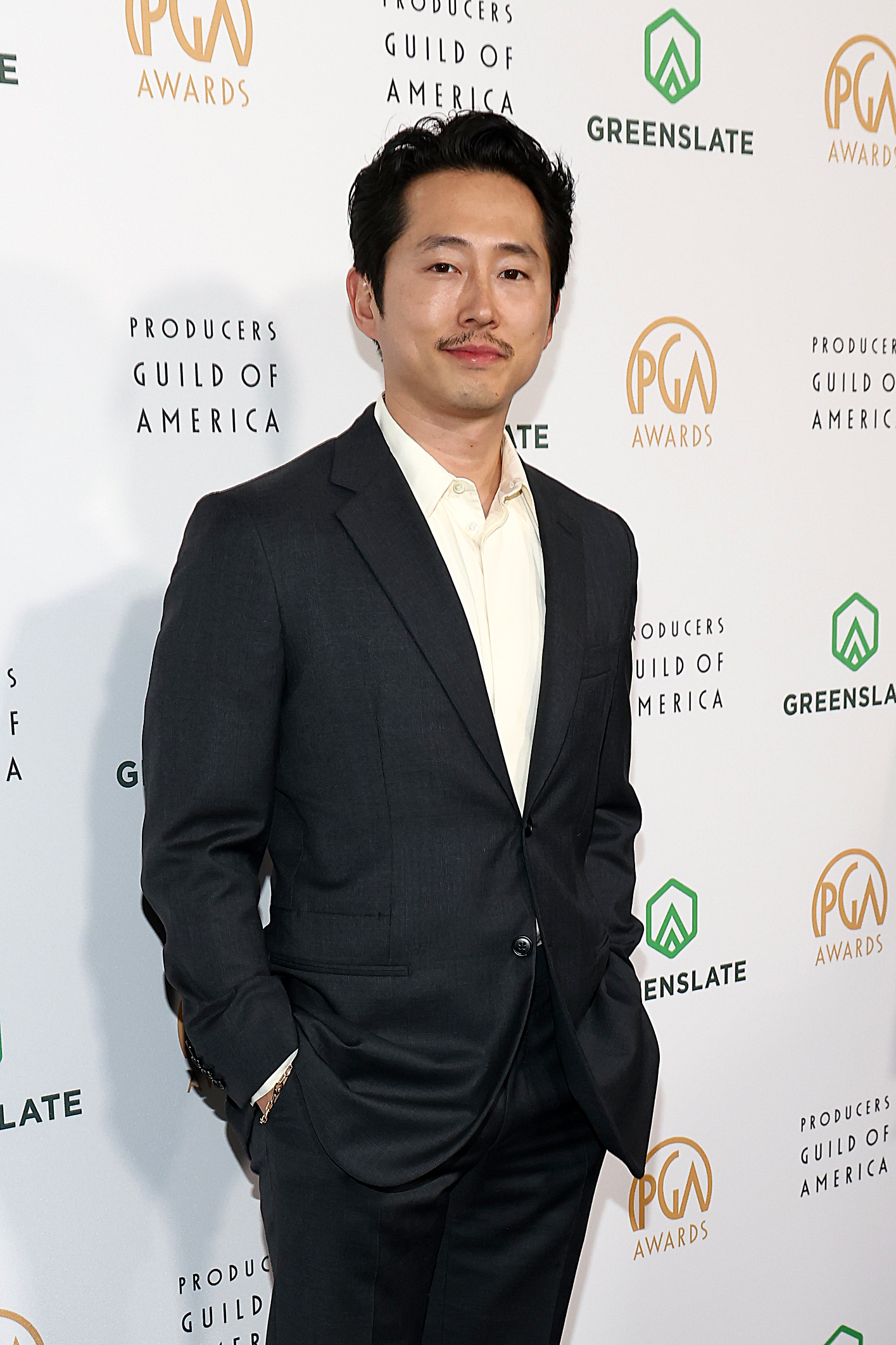 Steven in tailored suit sans tie poses at the Producers Guild Awards