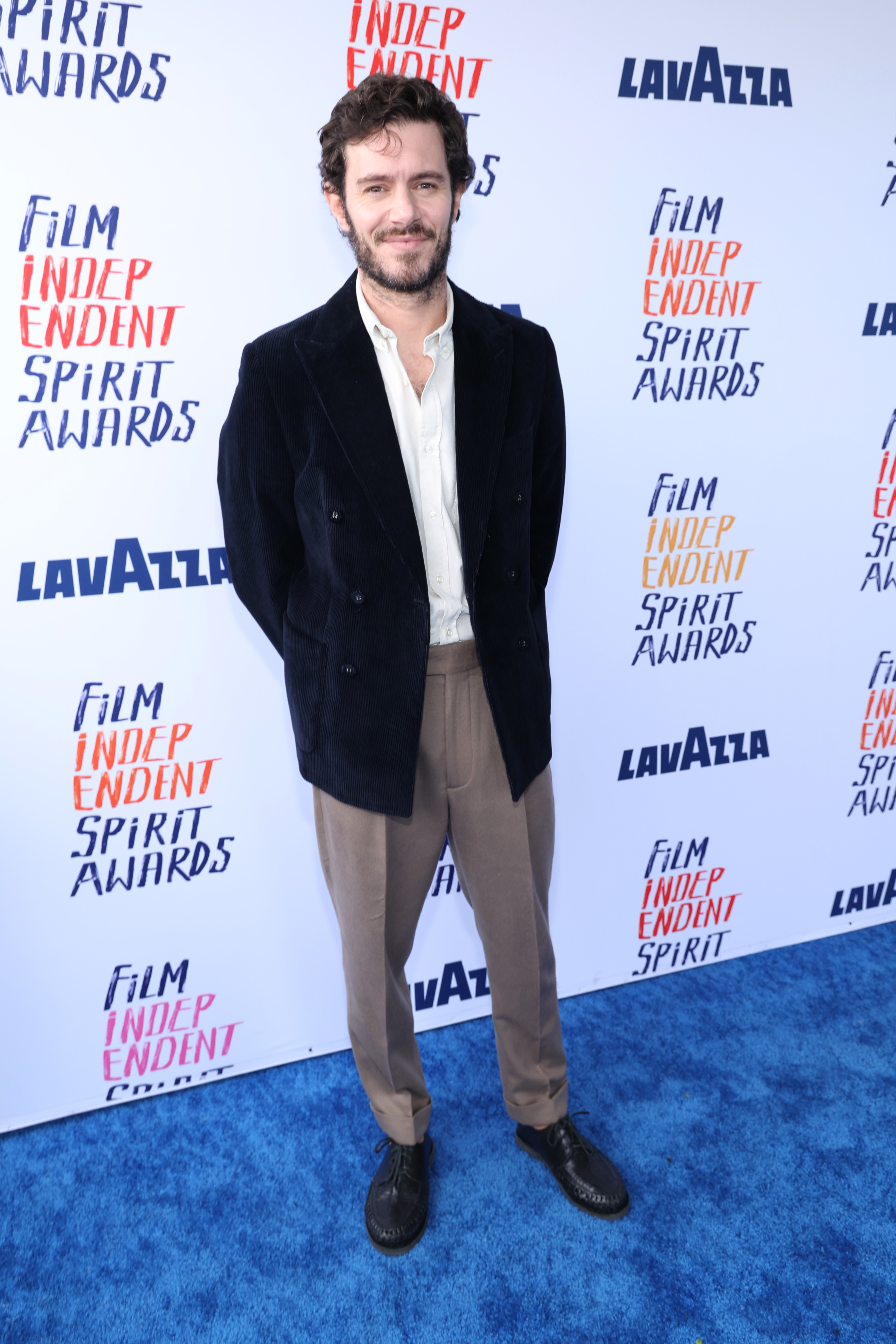 Adam in velvet jacket and trousers posing at the Film Independent Spirit Awards