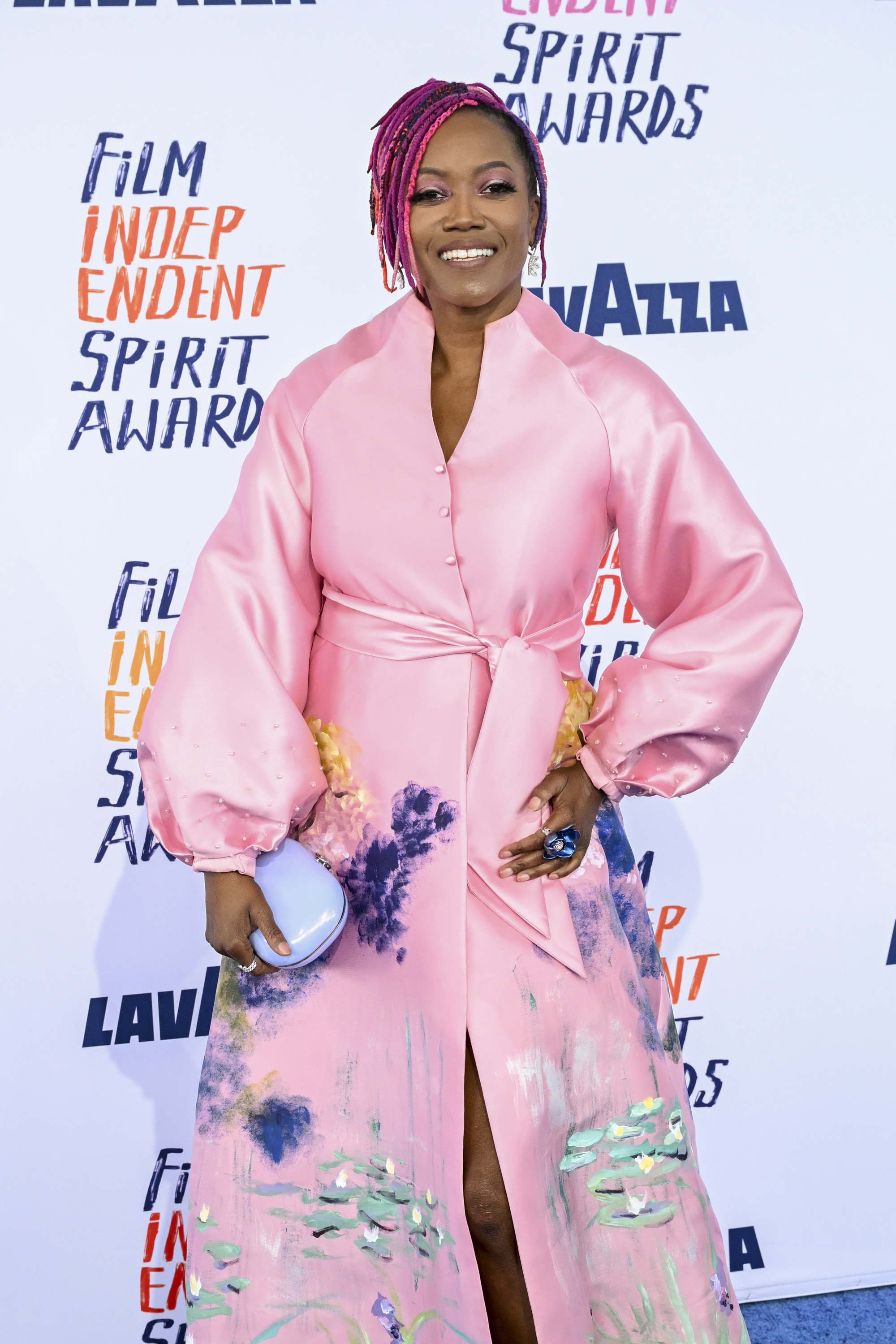 Erika in an outfit with balloon sleeves and painted accents, posing at the Film Independent Spirit Awards