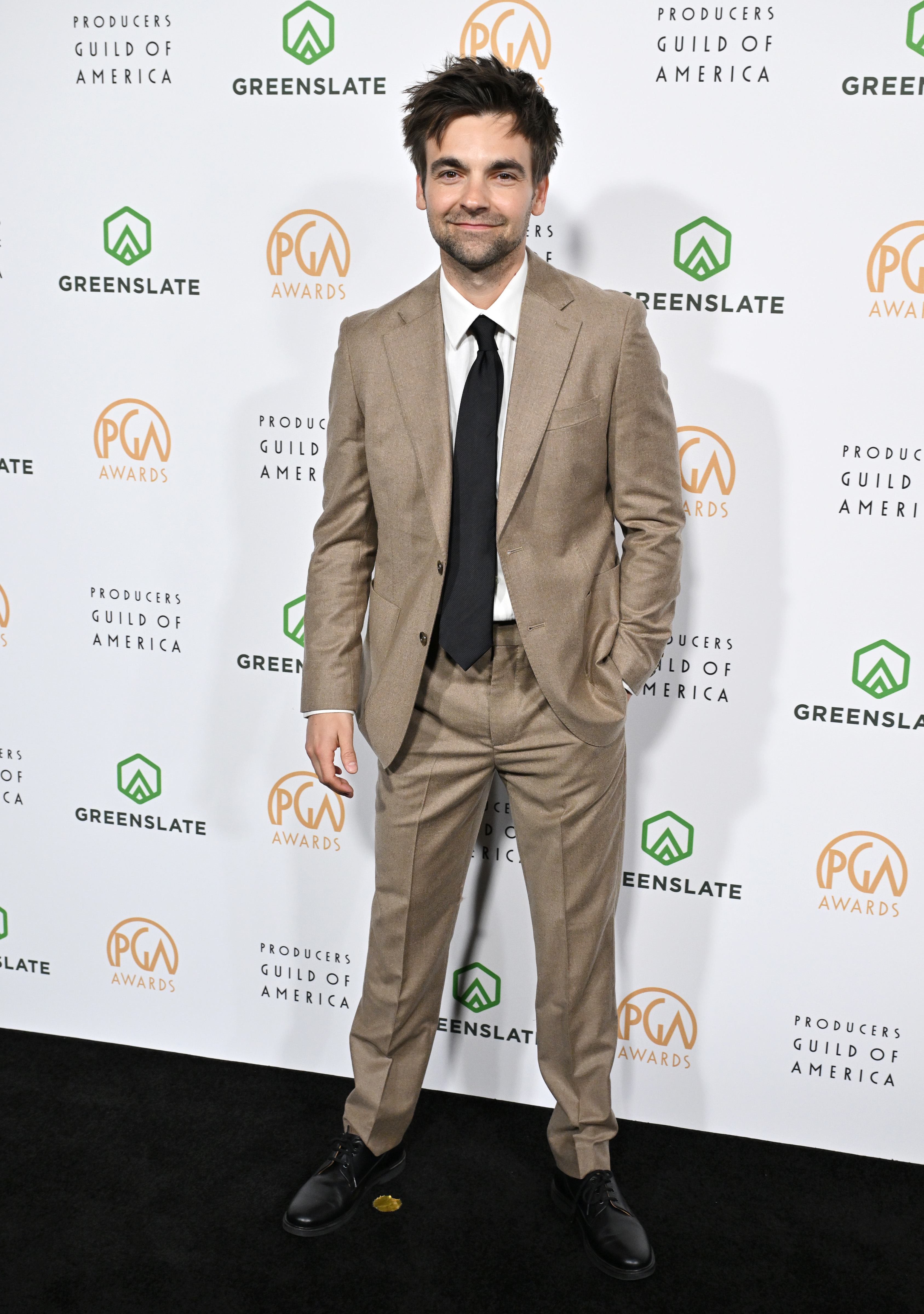 Drew in a tailored suit posing at the Producers Guild Awards
