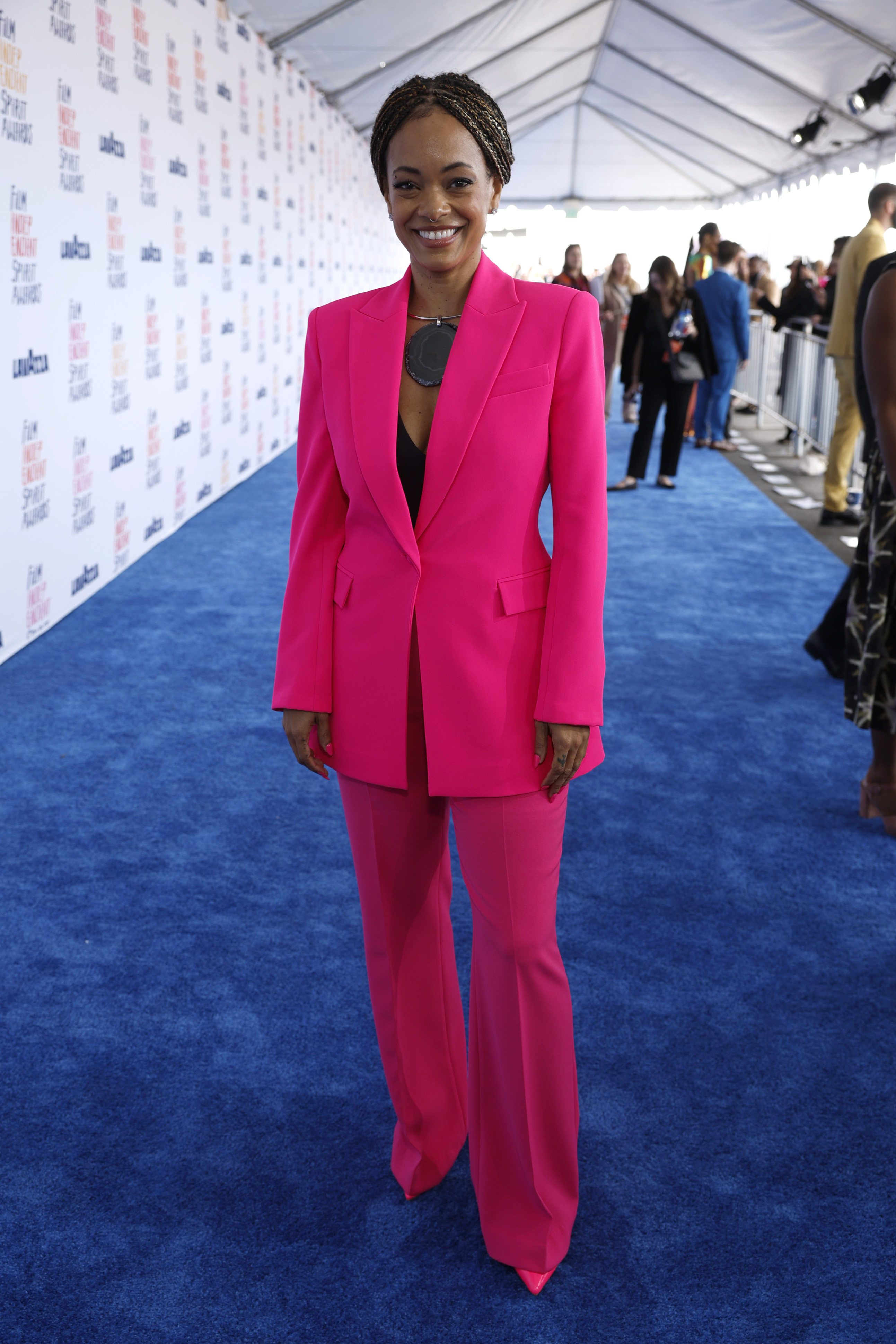 Stephanie Filo in a bright pantsuit with a top, smiling