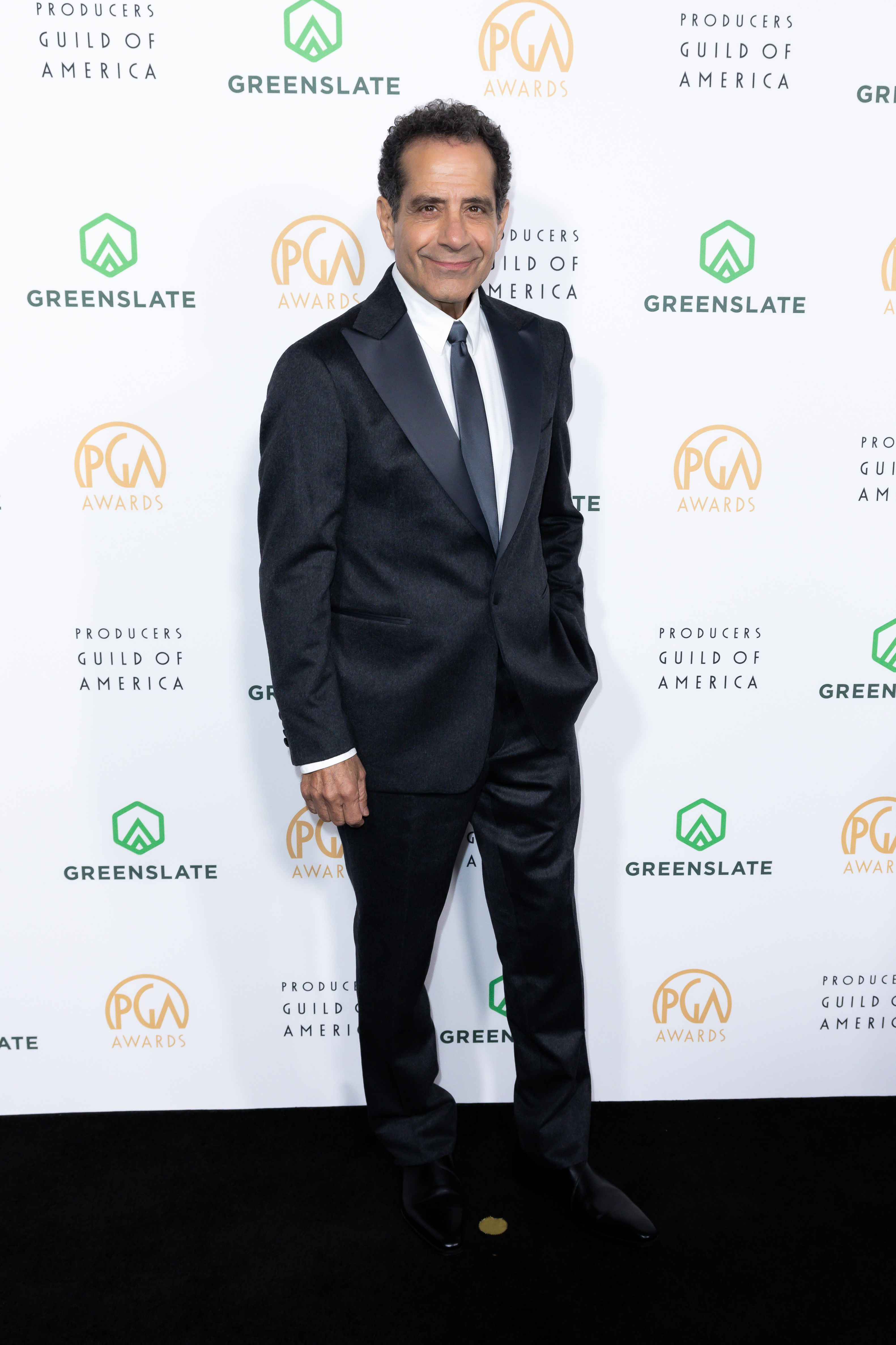 Tony Shalhoub in a suit poses at the Producers Guild Awards