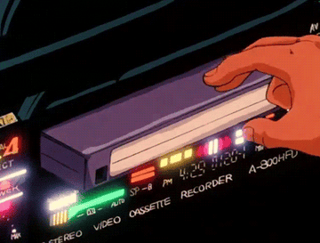 Un VCR con una mano insertando una cinta de video