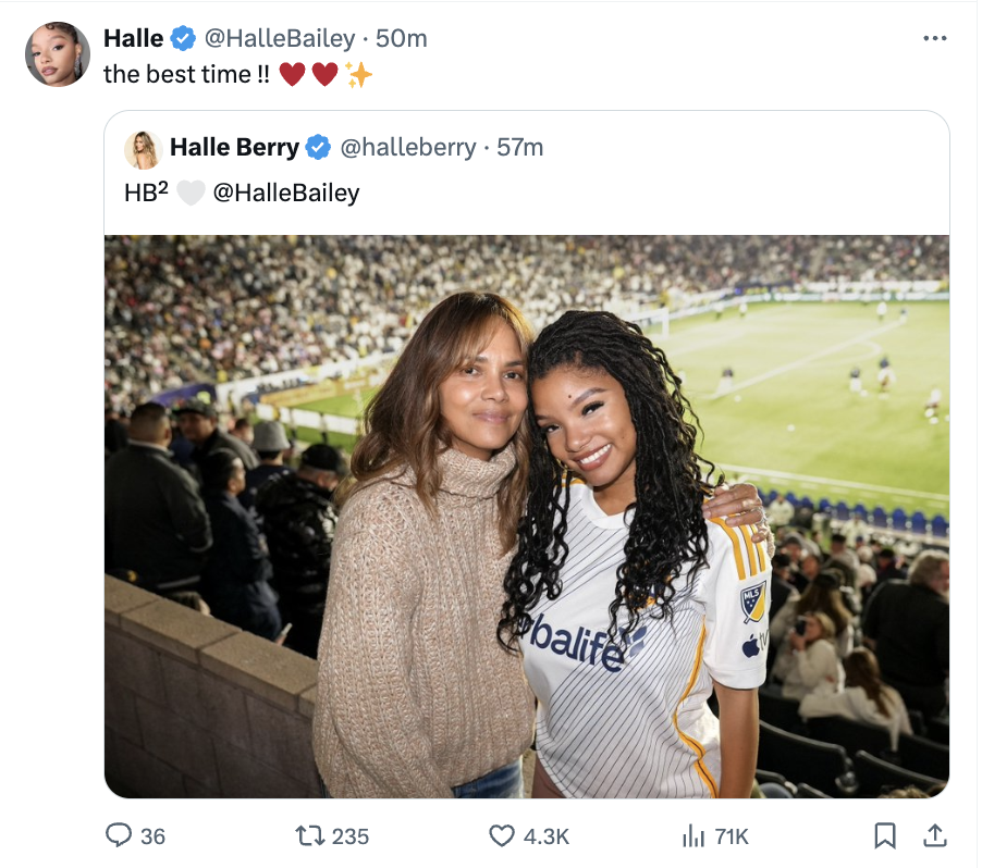 Two women smiling at a soccer game, one in a cozy sweater, the other in a sporty jersey. Text is a tweet expressing enjoyment at the event