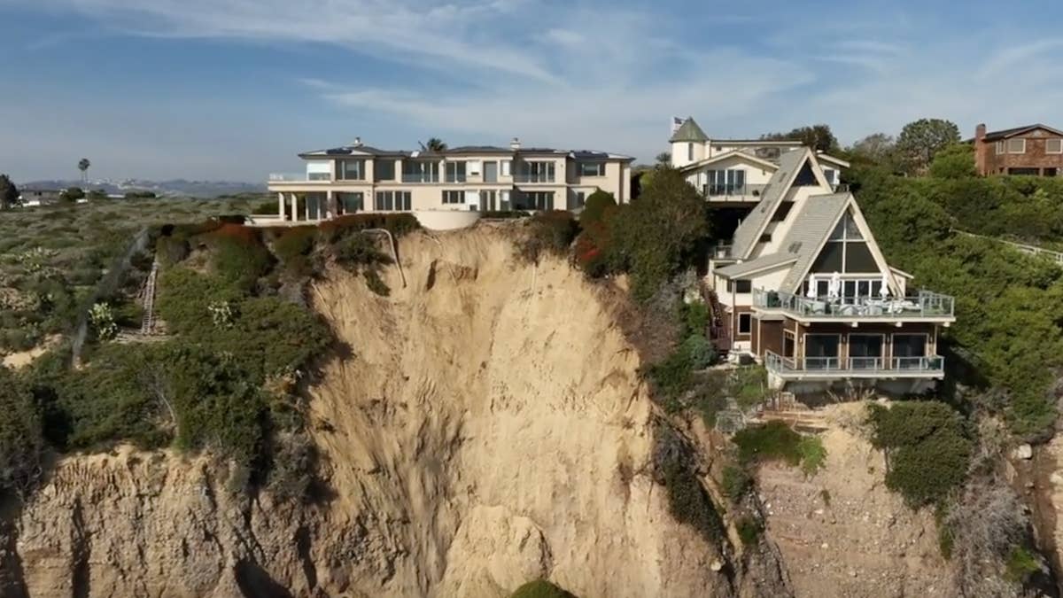 Heavy rainfalls in Southern California caused part of the cliff outside the home to fall into the Pacific Ocean.