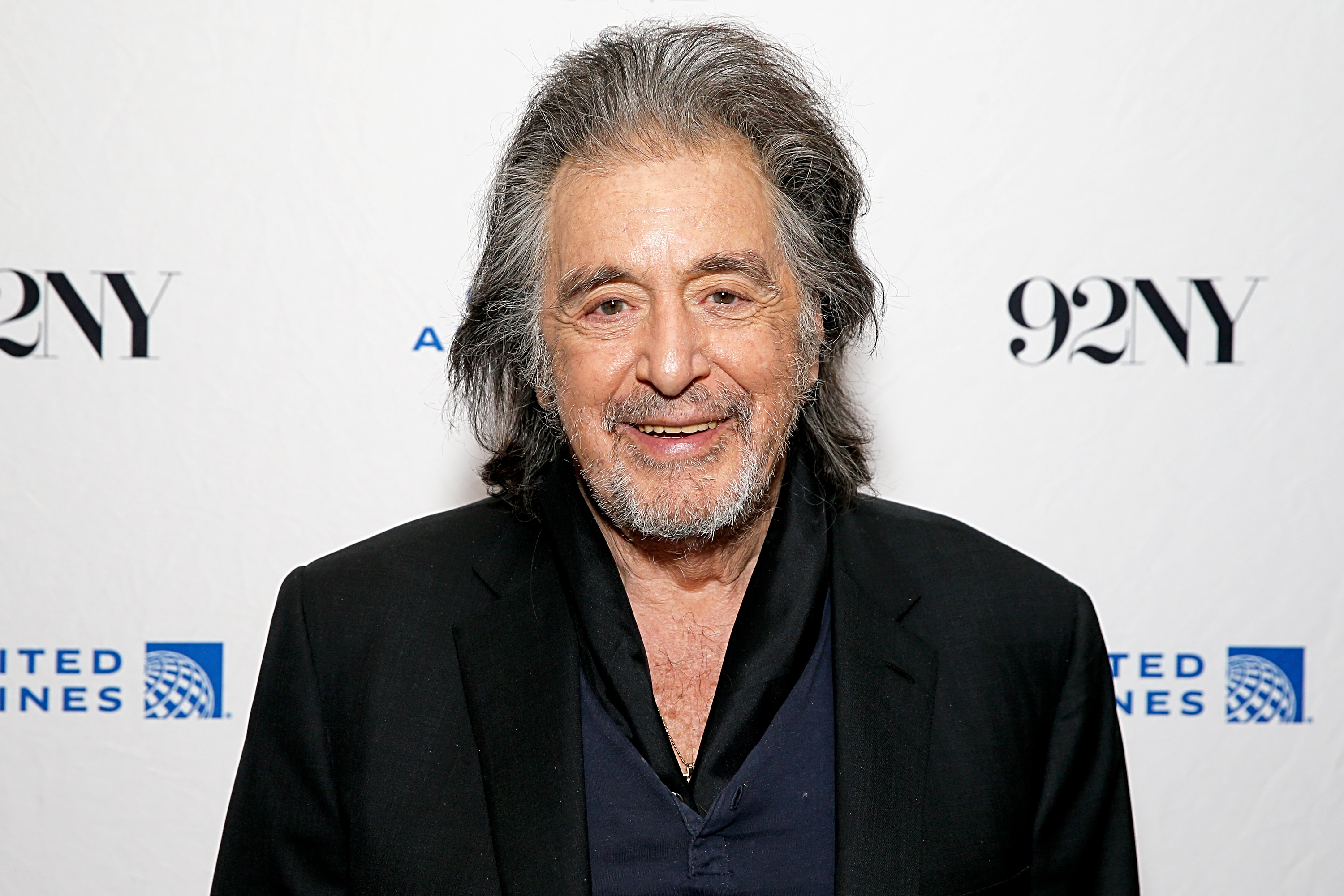 Al Pacino smiling in a suit at a 92NY event