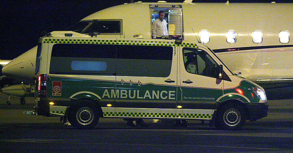 Ambulance vehicle parked, with opened back doors and visible medical equipment inside