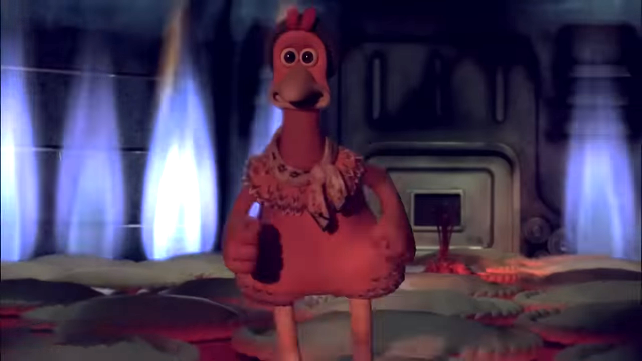 Animated character Ginger from Chicken Run, wearing a knitted pullover, stands in a dimly lit space