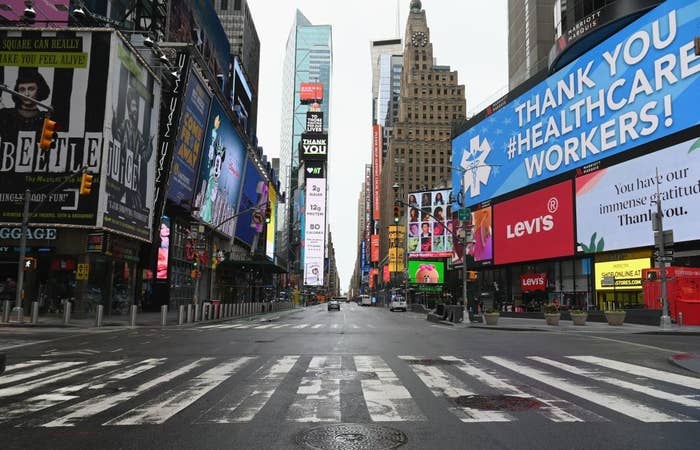 Empty Times Square with digital billboards displaying messages thanking healthcare workers