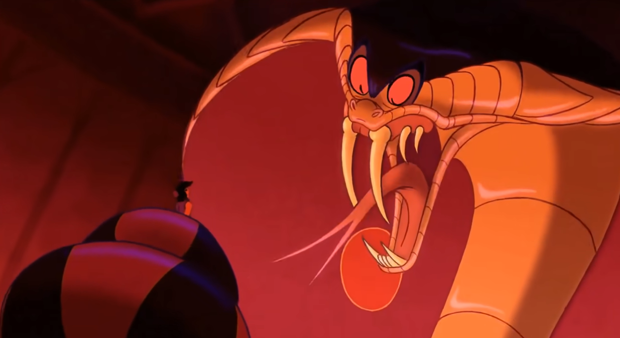 Jafar in his snake form looming over Aladdin in a scene from Disney&#x27;s animated film