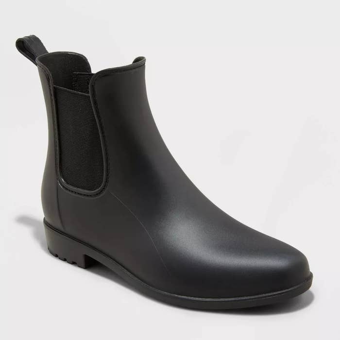 A single black Chelsea rain boot with elastic side panels
