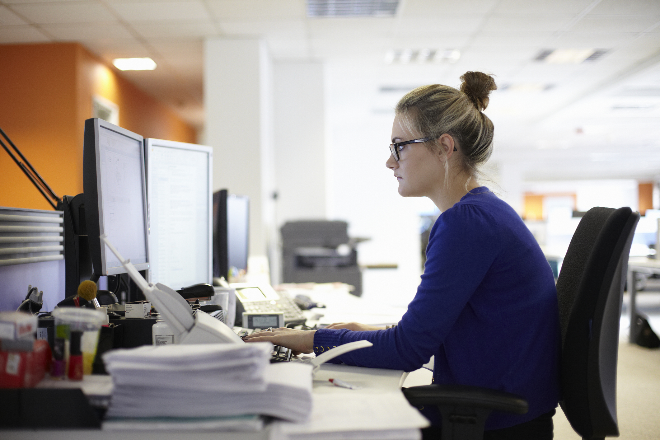 Woman at a desk using a computer in an office setting