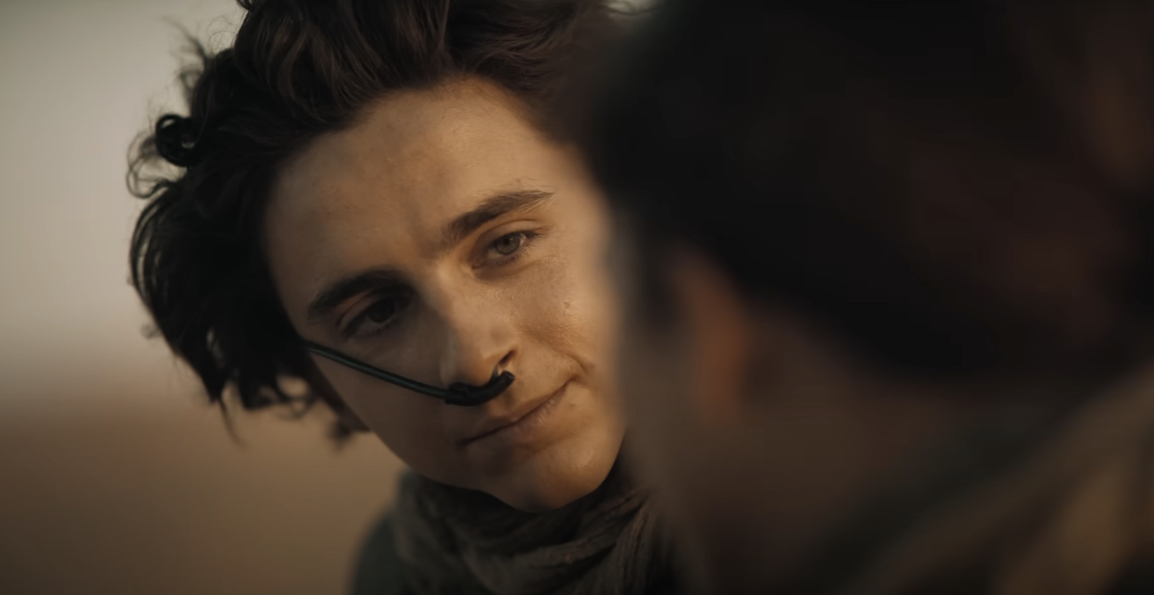 Close-up of Timothée Chalamet as Paul Atreides in Dune, looking intently at someone off-camera
