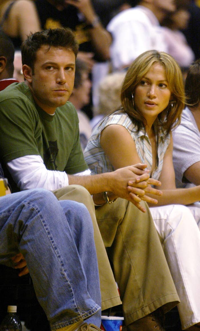 The couple is seated side by side at a sports event