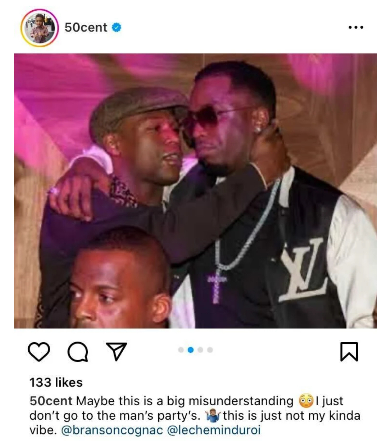 Diddy in a varsity jacket, hugging a man, both smiling, with onlookers. Used in music context