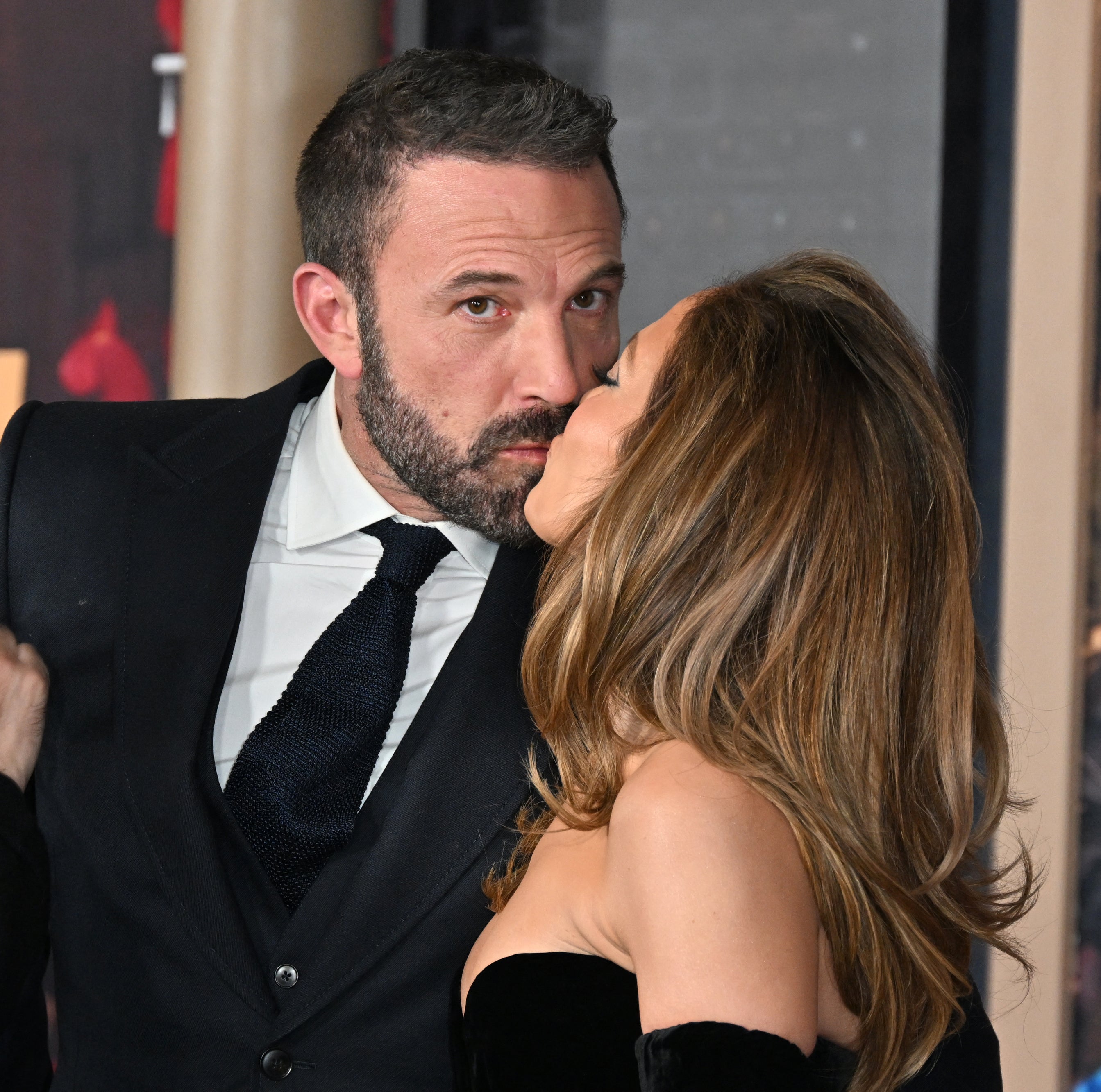 The couple sharing a kiss at an event