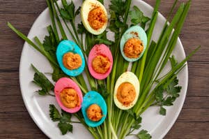 Plate with six deviled eggs garnished with parsley on a wooden table